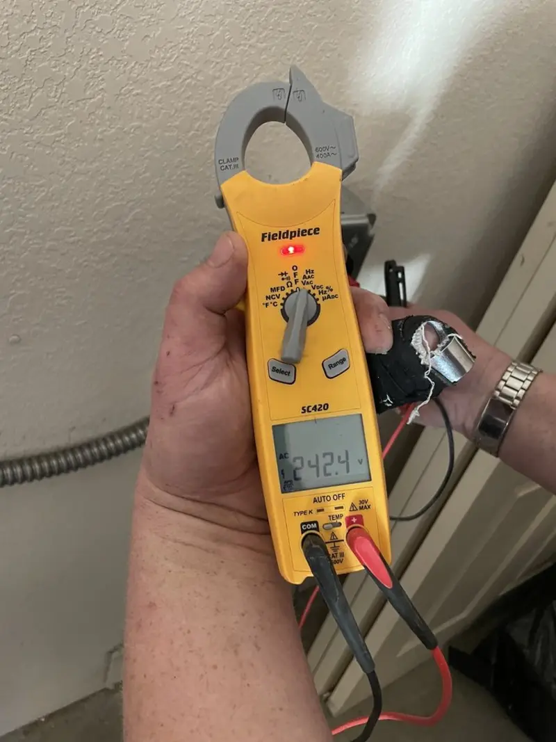 Voltage testing with clamp meter during Whole House Surge Protector in Wilbraham